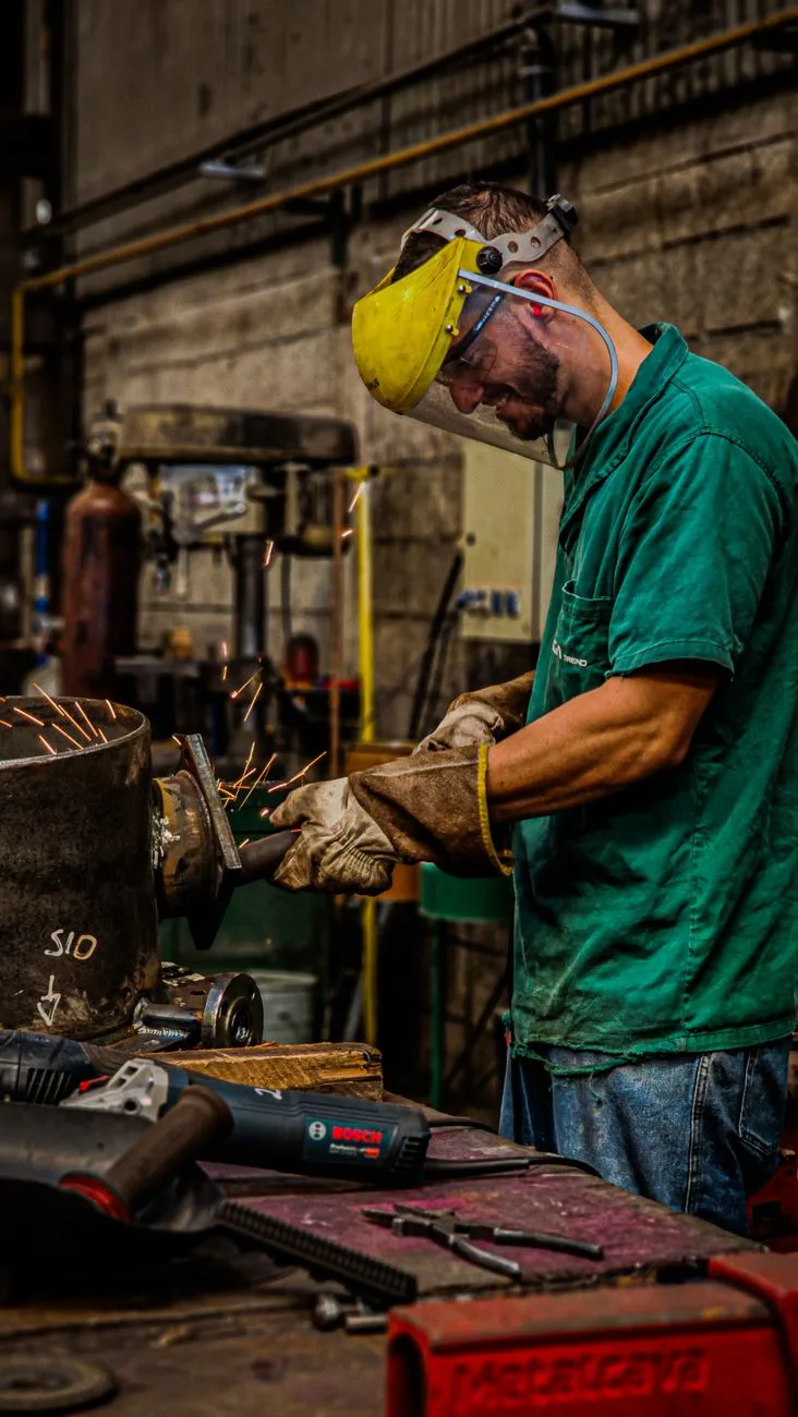 skilled welder working in industrial workshop